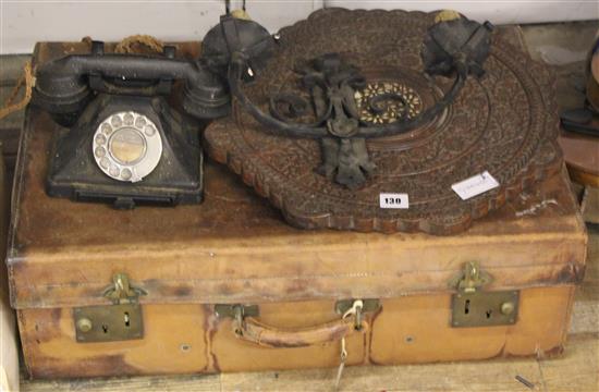 Leather suitcase, early phone table top and a wall light